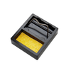 Black stamp with yellow ink pad on a white background